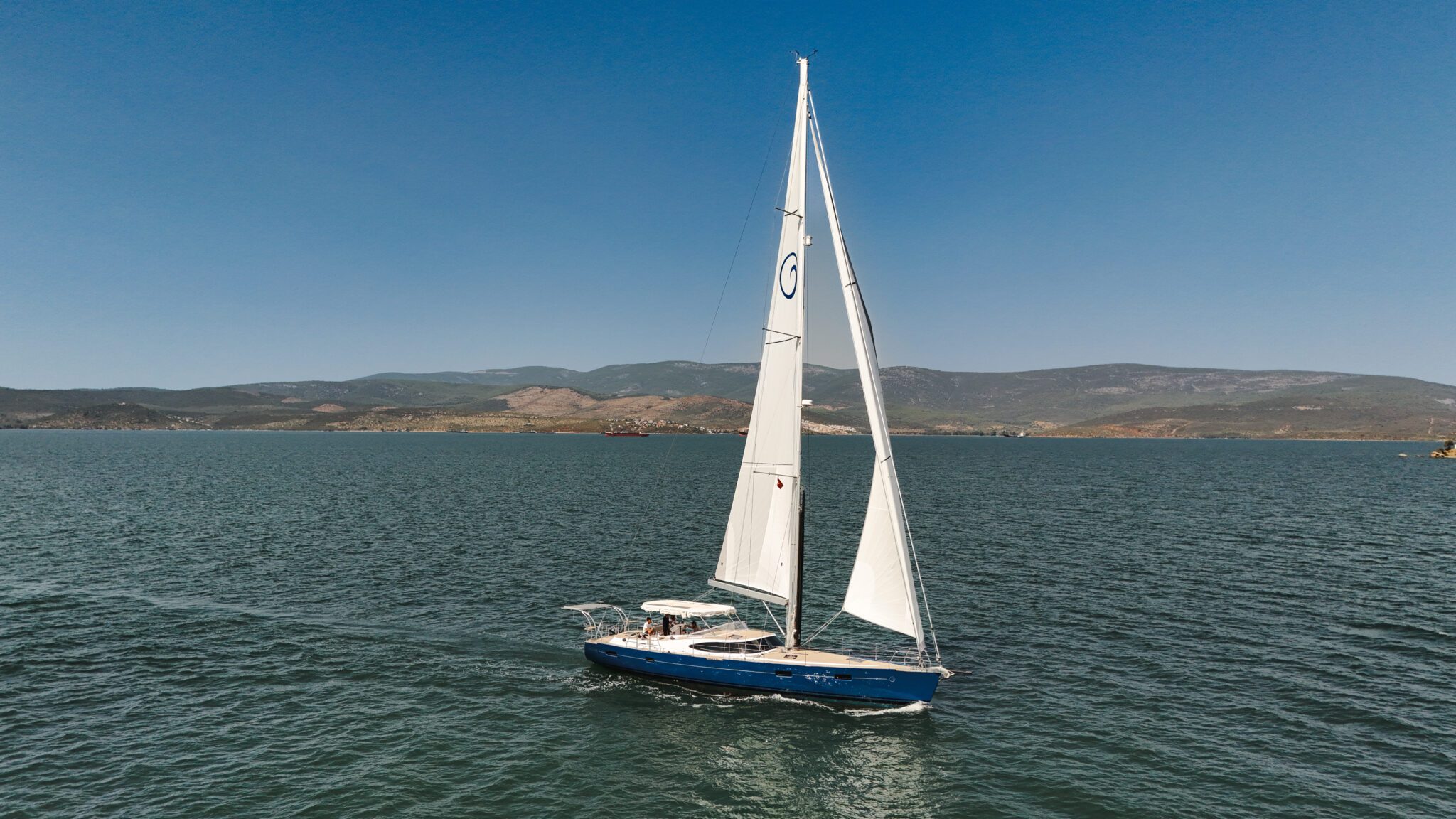 A blue-hulled Kraken 50 under full main and jib
